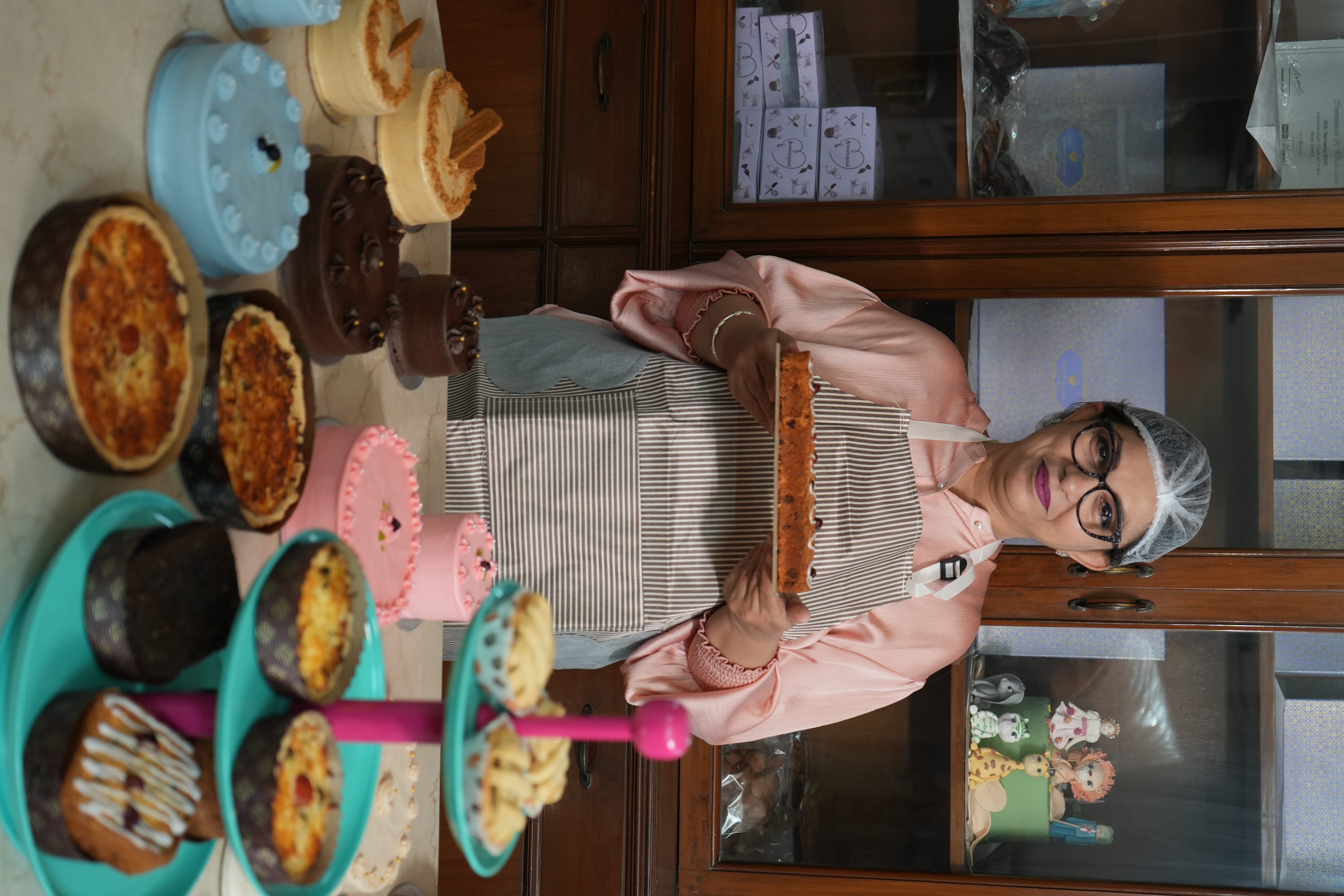 Our founder in the kitchen surrounded by beautiful cakes and desserts